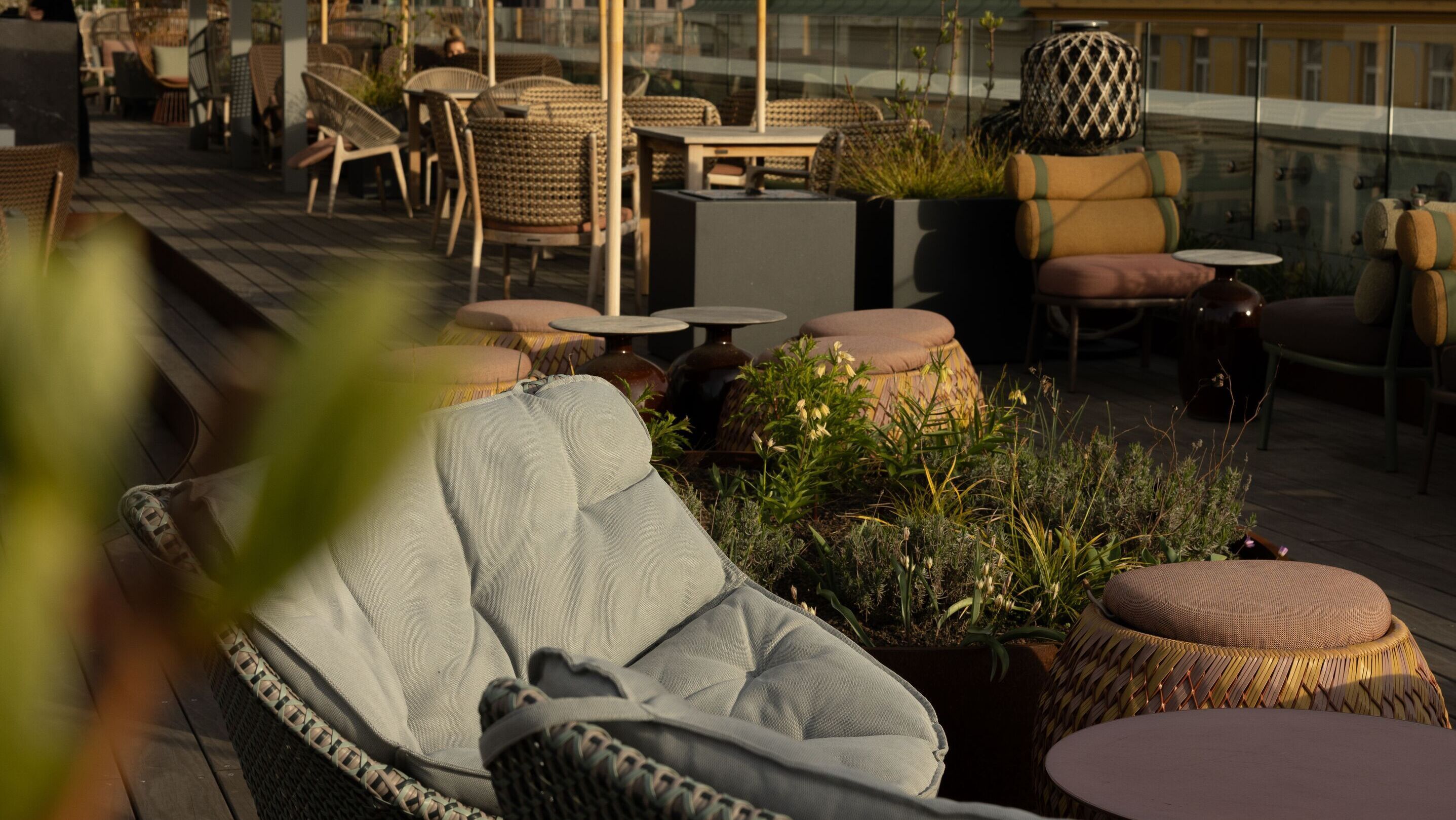 Designhotel Prag The Cloud One Dachterrasse mit mehreren Tischen und Stühlen sowie Sonnenschirme